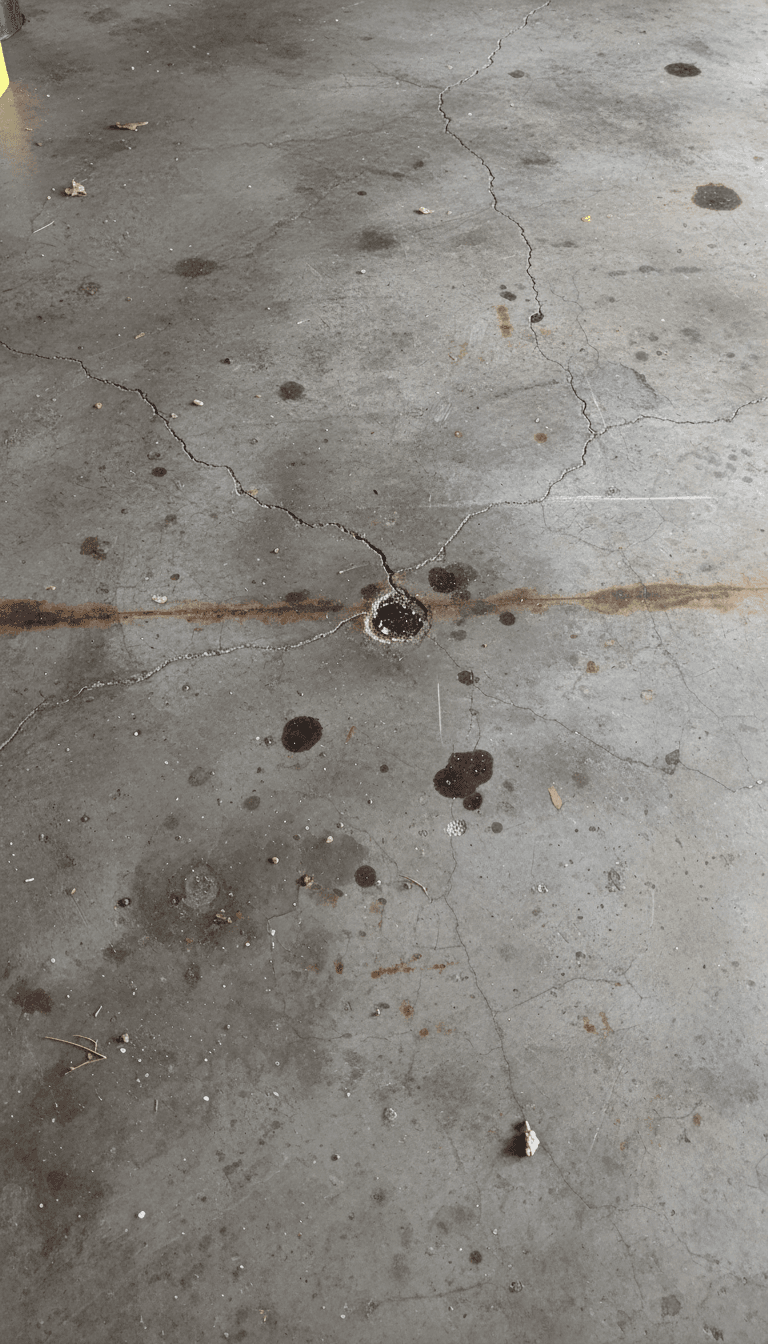 Before: Cracked and stained concrete garage floor